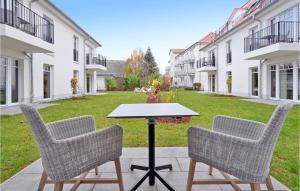 two chairs and a table in the middle of a courtyard at Baltischer Hof Apartment 13 in Boltenhagen