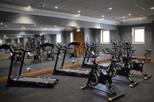 a gym with a bunch of tread machines in a room at Paradise Bay Resort in Mellieħa