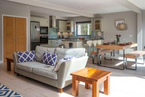 a living room and kitchen with a couch and a table at Liz's Lodge by Big Skies Cottages in Weybourne