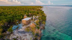an aerial view of a house on an island in the water at Hostel villa luz Beach in Tintipan Island