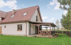 a white house with a red roof at 3 Bedroom Amazing Home In Jedwabno in Jedwabno