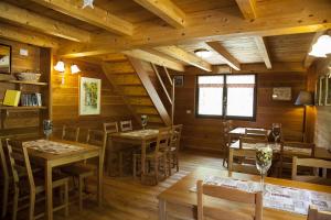 a restaurant with wooden walls and tables and chairs at Agriturismo Alagna in Alagna Valsesia