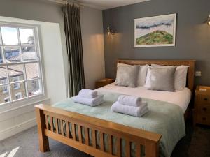 a bedroom with a bed with two towels on it at St Agnes Hotel in St. Agnes 