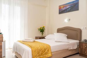 Postel nebo postele na pokoji v ubytování Hotel Alkyon