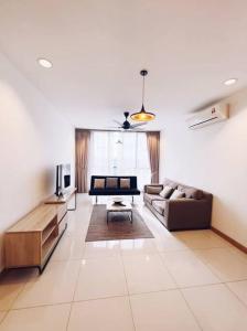 a living room with a couch and a television at [PROMO]Connected train 2 Bedrooms - Above Mall(25) in Kuala Lumpur