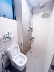 a white bathroom with a toilet and a shower at [PROMO]Connected train 2 Bedrooms - Above Mall(25) in Kuala Lumpur