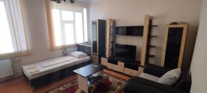 a living room with a couch and a tv at Arena Hotel Balakan in Balakǝn