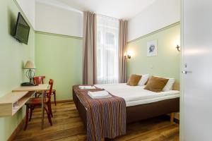 Postel nebo postele na pokoji v ubytování Koidulapark Hotell