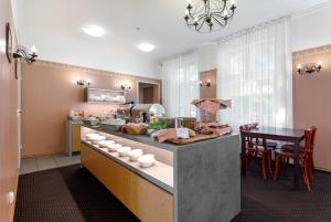 cocina con encimera con mesa y sillas en Koidulapark Hotell, en Pärnu