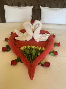 a heart made out of towels on a bed at Private guest house in five stars resort in Ras al Khaimah