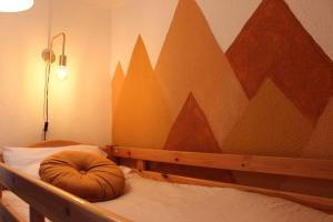 a bedroom with a bed with a mountain mural on the wall at Le P'tit Hélios 4-6 personnes - Centre ville de Barèges in Barèges