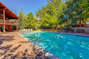 a swimming pool in front of a house at Red Pine Q8 in Park City