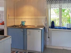 a kitchen with a sink and a dishwasher at Holiday home Smögen IV in Smögen