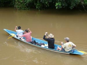 a group of people in a blue boat on the water at Cuyabeno River Lodge in Marian