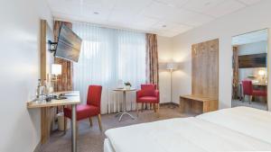 Postel nebo postele na pokoji v ubytování Hotel Kreuzer