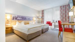 Postel nebo postele na pokoji v ubytování Hotel Kreuzer