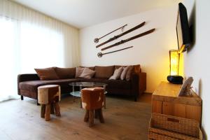 a living room with a couch and a table at Amor Lodge in Saas-Fee