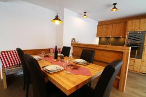 a wooden table in a kitchen with a dining room at Amor Lodge in Saas-Fee