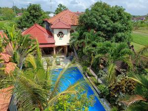 an aerial view of a house with a swimming pool at Ada Waktu Homestay in Yogyakarta