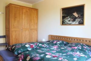 a bedroom with a bed and a wooden cabinet at StrandGut in Boltenhagen