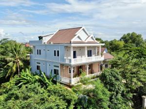 a house on top of a hill with trees at Realkhom Homestay in Siem Reap