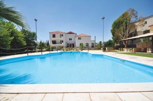 a large blue swimming pool in front of a building at Actor Hotel in Ligourio