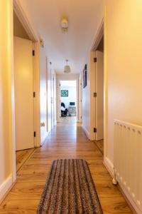 a hallway with a rug on a hard wood floor at Belfast Apartment in Belfast