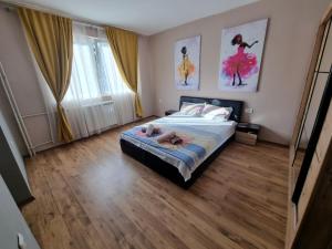 ein Schlafzimmer mit einem Bett mit zwei Schuhen drauf in der Unterkunft ELISA Apartment 20A Center-Skopje in Skopje