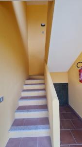 eine Treppe in einem Haus mit lila Fliesen in der Unterkunft Casa Il Pescatore in Porto Pozzo