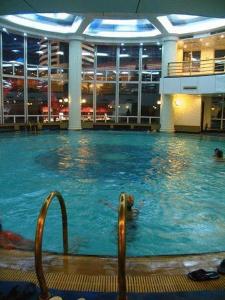 a large swimming pool in a building with people in it at Jinling Plaza Changzhou in Changzhou