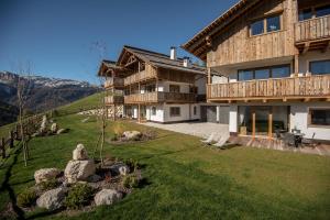 a house on a hill with a green yard at Appartements Chalet Bandiarac in San Cassiano
