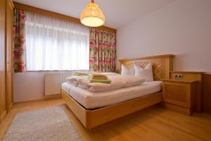 a bedroom with a bed with a large window at Apart Auer Umhausen in Umhausen