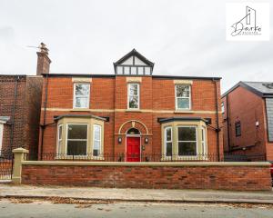 a red brick house with a red door at Apartment 2 - Beautiful 1 Bedroom Apartment Near Manchester in Worsley