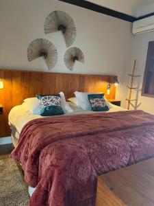 a bedroom with a large bed with two mirrors on the wall at Hotel Pousada Shangri-la in Serra Negra