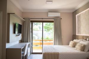 Postel nebo postele na pokoji v ubytování Hotel Pousada Kaster