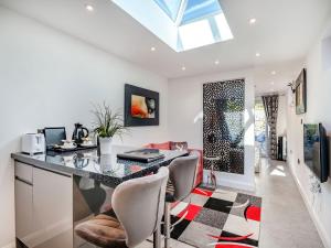 a home office with a desk and chairs at Little Heron - Uk40928 in Holdenhurst