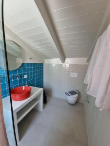 a bathroom with a red sink and a toilet at Julietta Suites in Argostoli