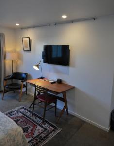 a room with a desk and a tv on a wall at The Astro in Santa Rosa