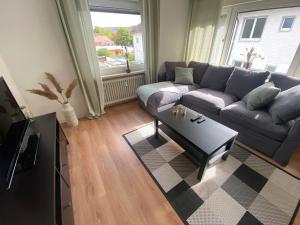 a living room with a couch and a coffee table at Apartments-Badharzburg / Ferienwohnung im Zentrum in Bad Harzburg