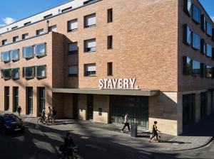 a rendering of a building with people walking in front of it at STAYERY Köln Ehrenfeld in Cologne