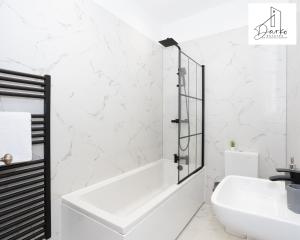 a white bathroom with a tub and a sink at Apartment 3 - Beautiful 1 Bedroom Apartment Near Manchester in Worsley