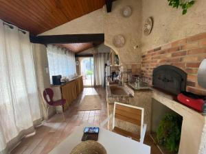 a kitchen with a fireplace and a table in a room at Mon coin de Provence petit-déjeuner offert in Roquevaire