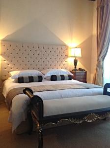a bedroom with a large bed with a large headboard at The Georgian Town House Hotel in Liverpool