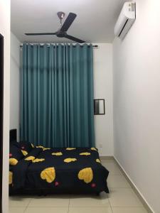 a bedroom with a bed and a blue curtain at MMG D'Bertam Homestay For Malay Only in Kampong Permatang Durian