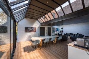 a large dining room with a table and chairs at Rue Haute by M&M 4 sterren bed en breakfast vlakbij Maastricht in Eben-Emael