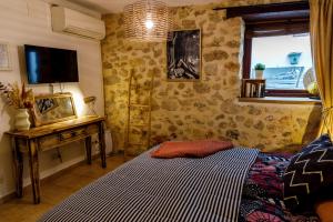 a bedroom with a bed and a table and a television at Dios Esta Bien in Peniscola