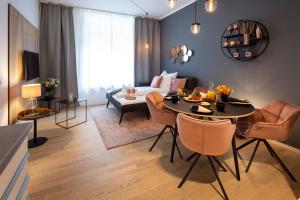 a living room with a table and a couch at Pure Berlin Apartments - Luxury at Pure Living in City Center in Berlin