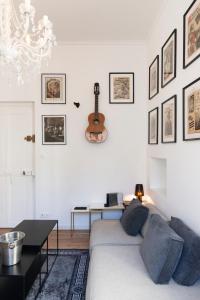 a white living room with a bed and a table at Le précieux de Nicolas in Nancy