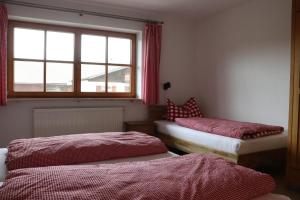 a room with two beds and a window at Ferienhaus Pfeiffer in Schwangau