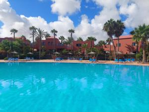 a large pool with blue water in a resort at Sweet Home by Sea You There Fuerteventura in Corralejo